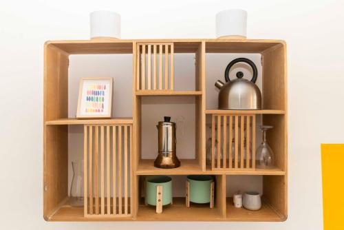a wooden shelf with various items on it at Urban House Carducci - Apartments in Turin