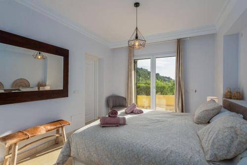 a bedroom with a large bed and a large window at Spacious ground floor apartment in Casares Costa in Casares