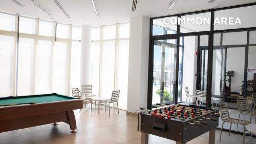 a room with a pool table and a sign at Beach Villas by Olala Homes in Ras al Khaimah