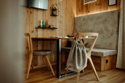a table and a chair with a bag on it at Appartement Wiederkehr in Flachau