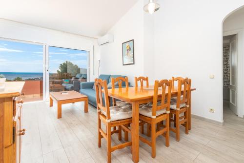 a kitchen and dining room with a table and chairs at Apartaments Aiguablava in Begur
