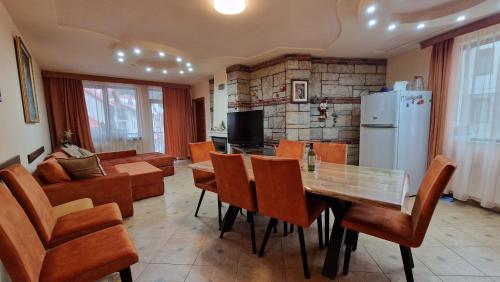 a kitchen and dining room with a table and chairs at Apartment 9 in Pamporovo