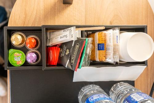 a drawer filled with different types of food and drinks at B&B HOTEL Massy Gare TGV in Massy