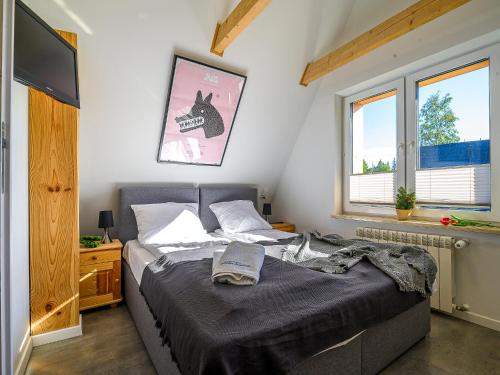 a bedroom with a bed and two windows at VisitZakopane - Willa Plan Apartments in Zakopane