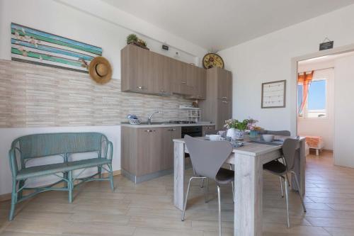 a kitchen and dining room with a table and chairs at L`Ebrezza by BarbarHouse in Campomarino