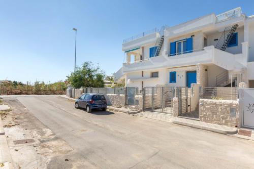 a car parked on a road in front of a house at L`Ebrezza by BarbarHouse in Campomarino