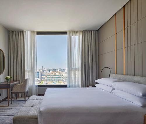 a hotel room with a bed and a large window at Crowne Plaza - West Cairo Arkan, an IHG Hotel in 6th Of October