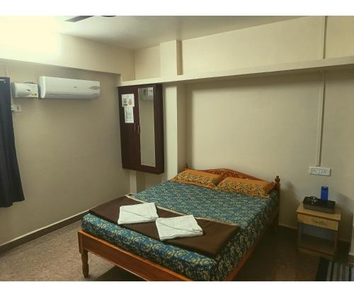 a room with a bed in a room with at Aqua Horizon in Port Blair