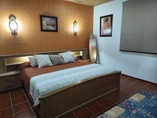 a bedroom with a bed and two lights on the wall at Casa Antiquada in Albufeira