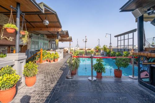 a patio with potted plants and a swimming pool at Best Western Merrion in Amritsar