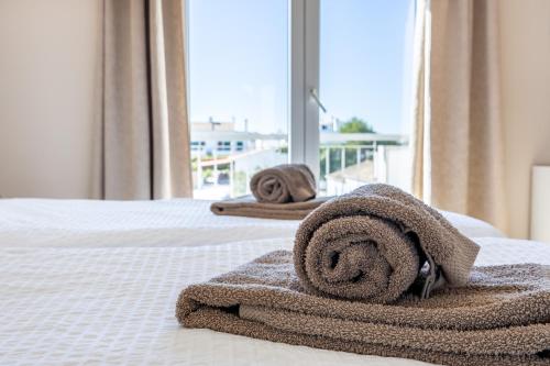 a couple of towels on a bed with a view at Your Villa Algarve Private pool 5 min walk to beach in Burgau