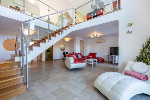 an open living room with a staircase and a living room at Your Villa Algarve Private pool 5 min walk to beach in Burgau