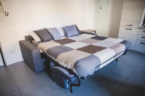 a large bed in a room with at Grey House Pavia in Pavia