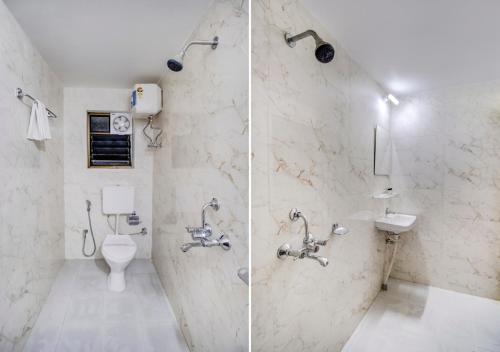 a bathroom with two sinks and a toilet at Hotel Sai Rain Tree in Guwahati