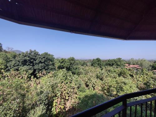 a view of a forest from a balcony at Bhanu The Fern Forest Resort & Spa, Jambughoda in Jambughoda