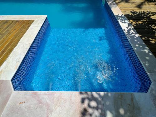 a swimming pool with blue water at Pousada Altas Natureza in Florianópolis