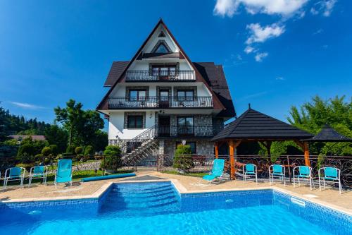 a house with a pool in front of it at DW Paweł in Zakopane