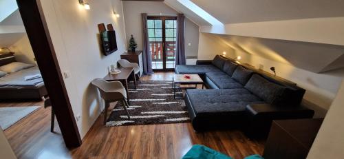 a living room with a couch and a table at Apartman Deluxe villa Barbora Hrabovo in Ružomberok