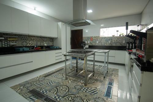 a kitchen with a table on a tile floor at Hotel Araçás in Carolina