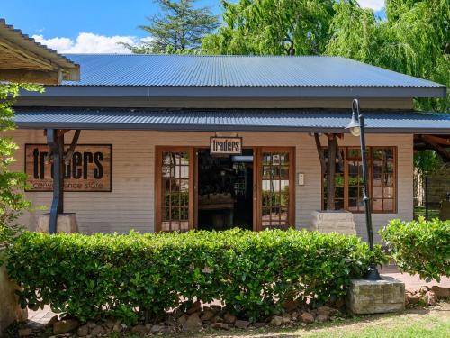 a small building with a sign in front of it at Kiara Lodge in Clarens
