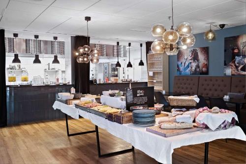 a table with food on it in a restaurant at Best Western Hotel Halland in Kungsbacka