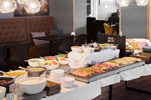 a buffet of food on a table in a restaurant at Best Western Hotel Halland in Kungsbacka