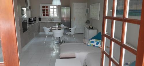 a kitchen with a couch and a table in a room at CASA JABLILLO in Costa Teguise