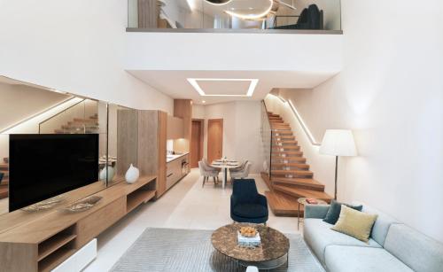 a living room with a couch and a tv at SLS Dubai Hotel & Residences in Dubai