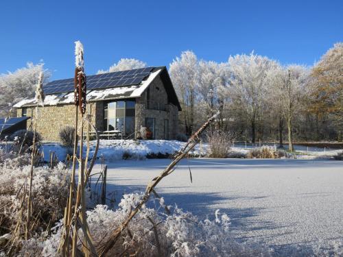 a house with snow on the ground and a building at Oxygen House, long weekend special in Ovifat