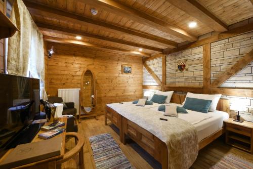A bed or beds in a room at Ethno Houses Plitvice Lakes Hotel