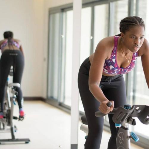 a woman is working out in a gym at Pier Harbour Residences and Spa in Lagos