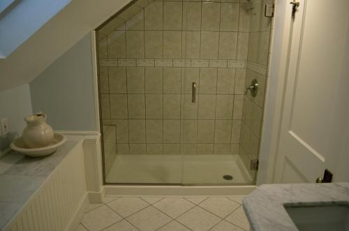 a shower with a glass door in a bathroom at Victoria Inn in Hampton