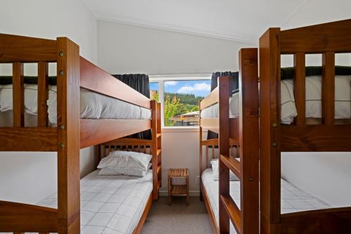 a room with three bunk beds and a window at Thyme Away - Clyde Holiday Home in Clyde