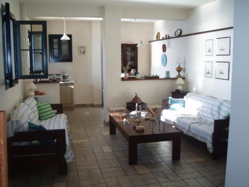a living room with a couch and a coffee table at Villa with breathtaking views and private beach in Agios Dimitrios
