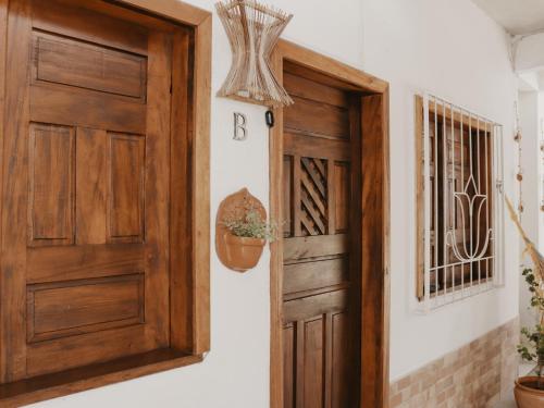 an open wooden door in a room with at Flats Beija-Flor in Itacaré