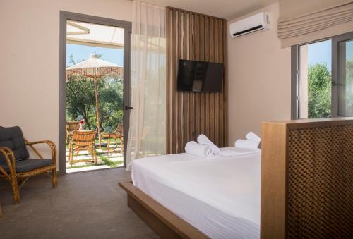 a hotel room with a bed and a sliding glass door at Elaia Grove in Kalamata