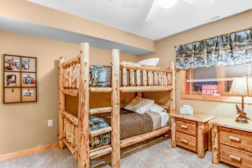 a bedroom with two bunk beds and a desk at On the Lake at Castle Rock in Necedah