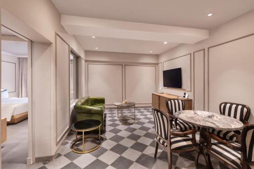 a hotel room with a bed and a table and chairs at Fortune Valley View, Manipal - Member ITC Hotels' Group in Manipala