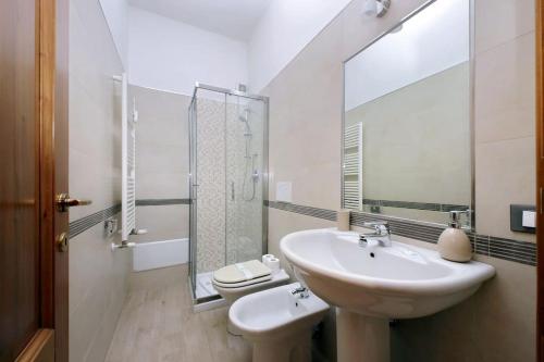 a bathroom with a sink and a toilet and a mirror at Casa Testaccio in Rome