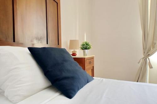 a blue pillow sitting on top of a bed at Casa Testaccio in Rome