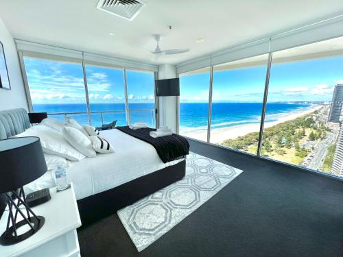a bedroom with a bed and a view of the ocean at Air on Broadbeach Beachfront 2Level stunning apartment with 180 degree views in Gold Coast