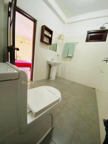 a bathroom with a toilet and a sink at Nature Walk Resort in Kandy