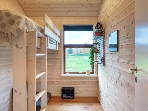 a tiny house with a staircase and a window at Holiday home Stubbekøbing VII in Stubbekøbing