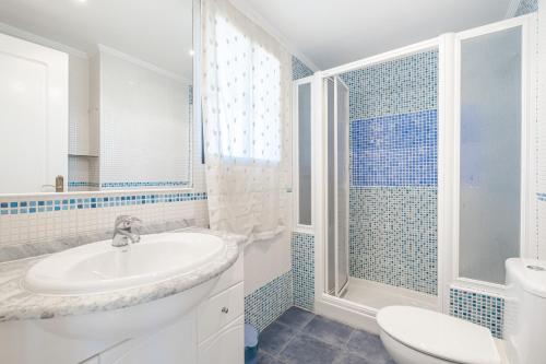 a white bathroom with a sink and a toilet at Trinisol 7-A Sea Views Apartment Levante Beach in Benidorm