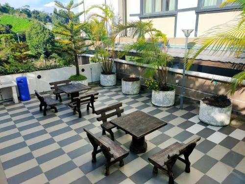 a patio with tables and benches on a building at The Retreat Sweety 3BR H/Stay in Brinchang