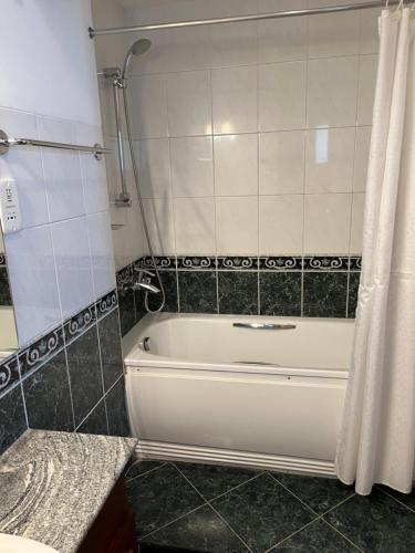 a white bath tub in a bathroom with a shower at Hedges Court Residencies -Town Hall- 2 Room 3 Bed Apartment in Colombo