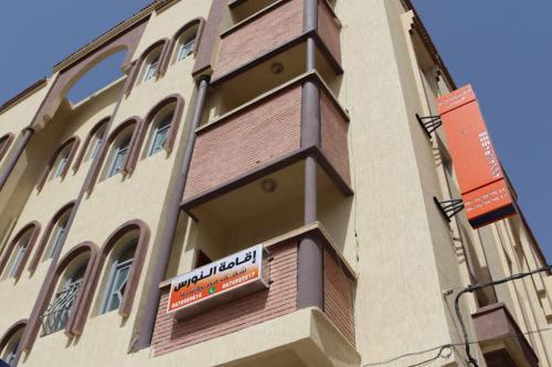 a building with a sign on the side of it at residance annawrasse in Laayoune