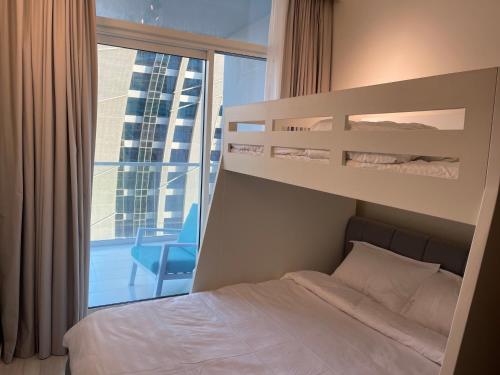 a bedroom with a bed and a large window at New Luxury Modern Canal View. in Dubai