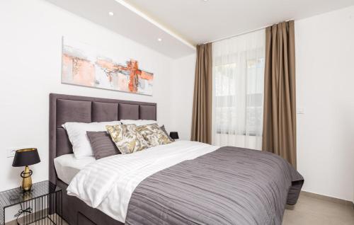 a bedroom with a large bed and a window at Villa Milla in Opatija