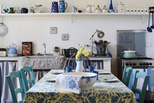 a kitchen with a table with a blue and white table cloth at F&F vista Lago in Cernobbio